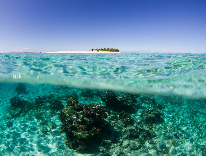 image of namotu island above clear blue water