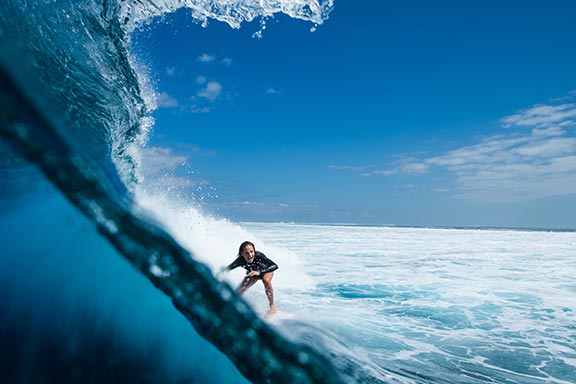 girl-riding-big-wave-at-wilkes-passage-namotu-island-fiji