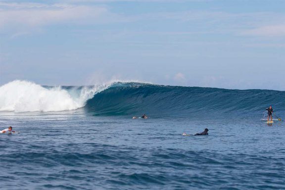 surfers-and-stand-up-paddle-boarder-at-surf-break-near-namotu-island-fiji